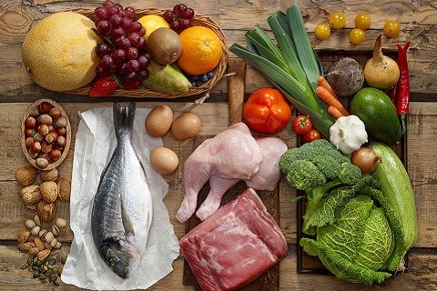 Various Paleo diet products on wooden table, top view